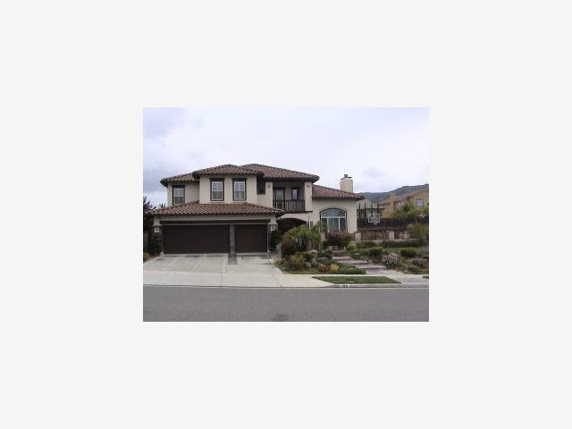 A large house with a lot of trees in front