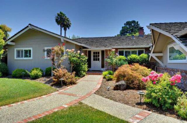 A house with a garden and walkway in front of it