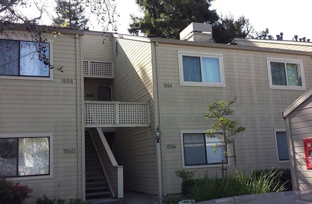 A building with stairs going up the side of it.