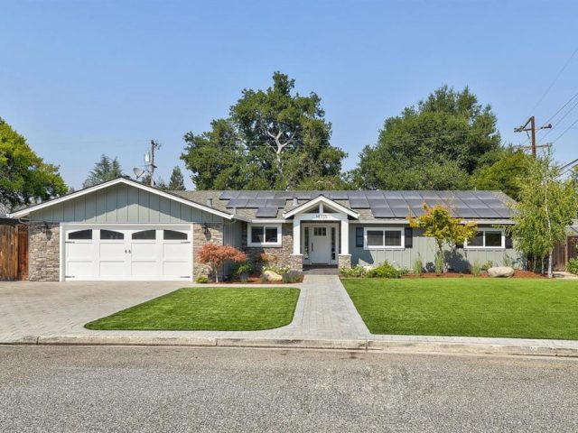 A house with two garage doors and a driveway.