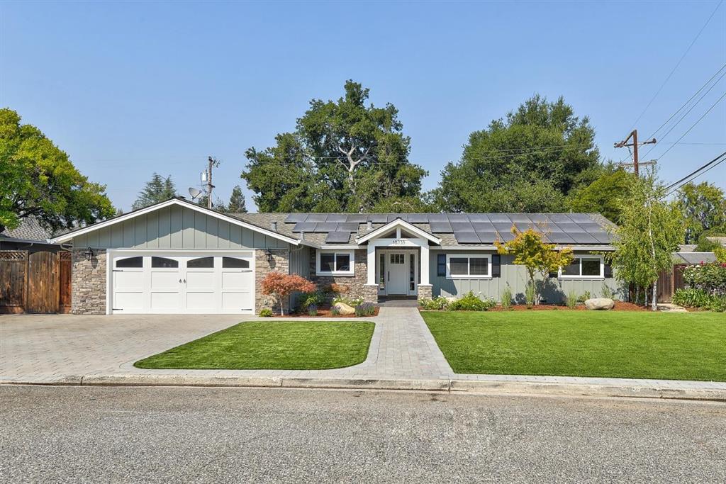 A house with two garage doors and a driveway.