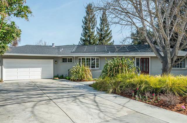 A house with a driveway and garage in front of it.