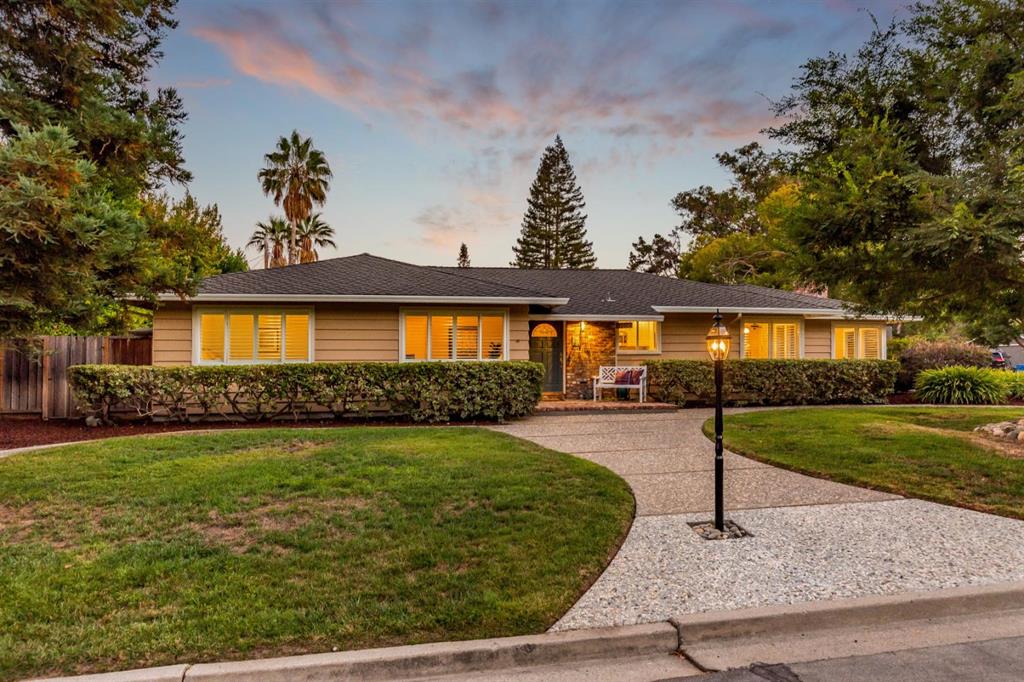 A house with a driveway and lawn in front of it