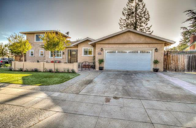 A house with a driveway and garage in front of it.