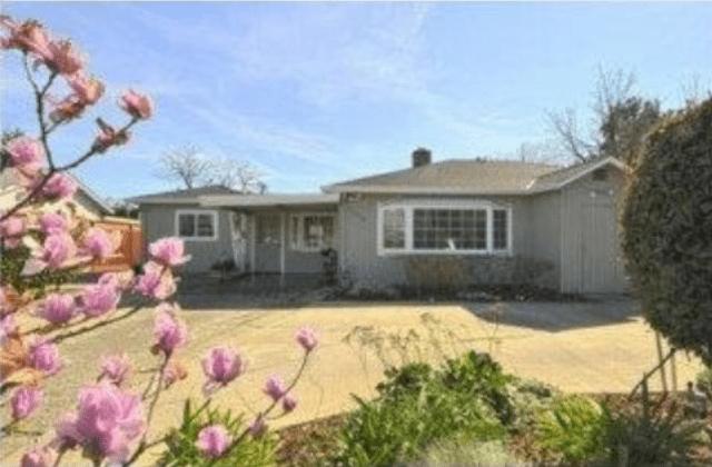 A house with flowers in front of it