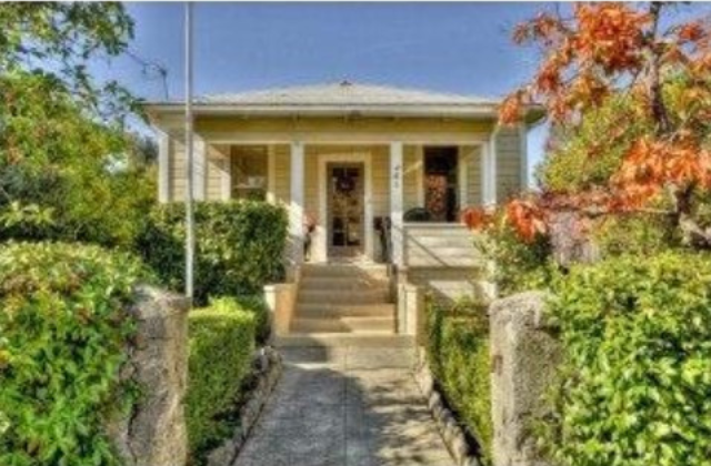 A house with steps leading to the front door.