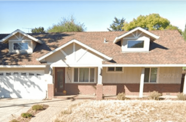 A house with brown roof and white trim.