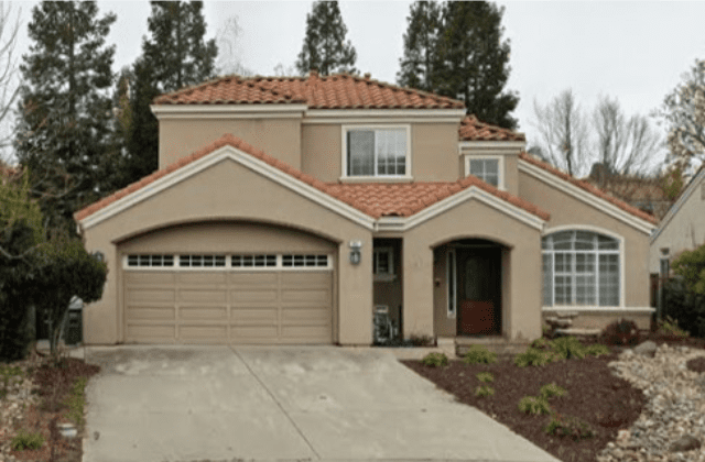 A house with two garage doors and a driveway.