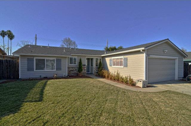 A house with grass and trees in front of it