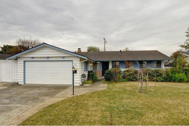 A house with a driveway and garage in front of it.