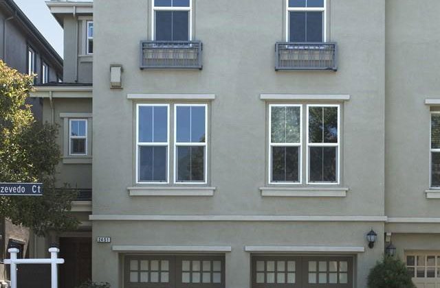 A building with two garage doors and windows.