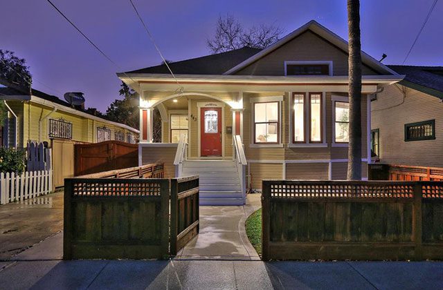 A house with a red door and white fence.