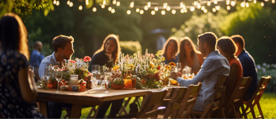 A group of people sitting at a table with food.